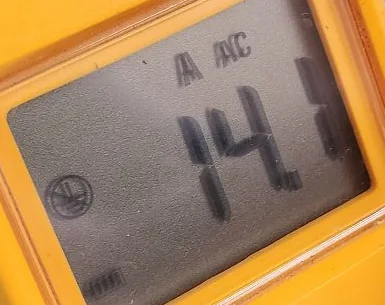Clamp-meter display showing 14.1 amps during the hot-water repair